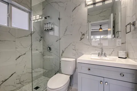 a bathroom with a sink toilet and shower