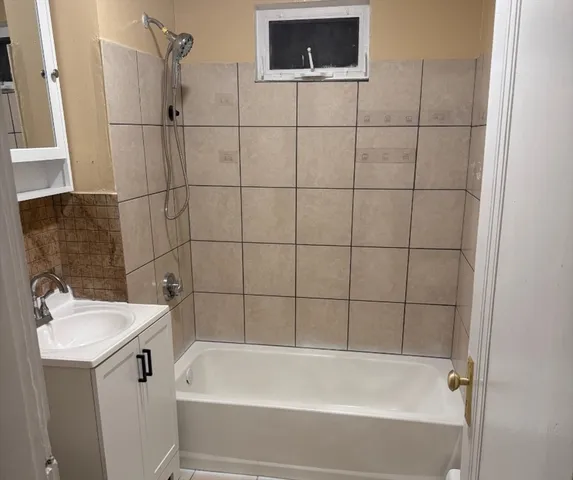 a bathroom with a bathtub and sink