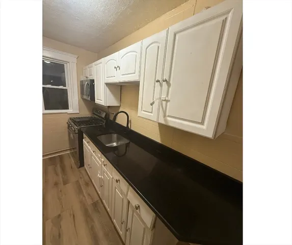 a kitchen with a sink and a mirror