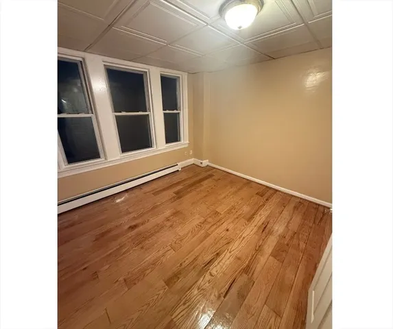 a view of an empty room with closet and entryway