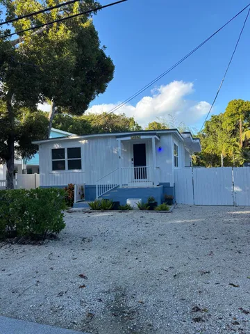 a backyard of a house with plants and outdoor seating