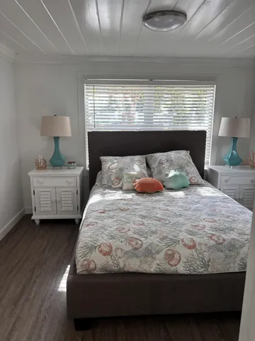 a bedroom with a bed and window