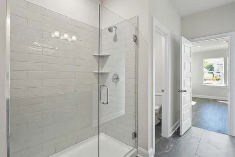 a bathroom with a glass shower door
