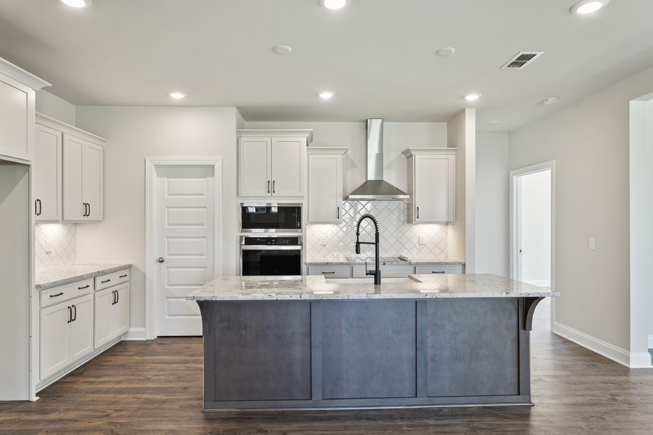 1108 Riverview Run Madison, TN 37115 - Photo 4 of 23 a large kitchen with stainless steel appliances granite countertop a stove a sink a refrigerator and white cabinets with wooden floor