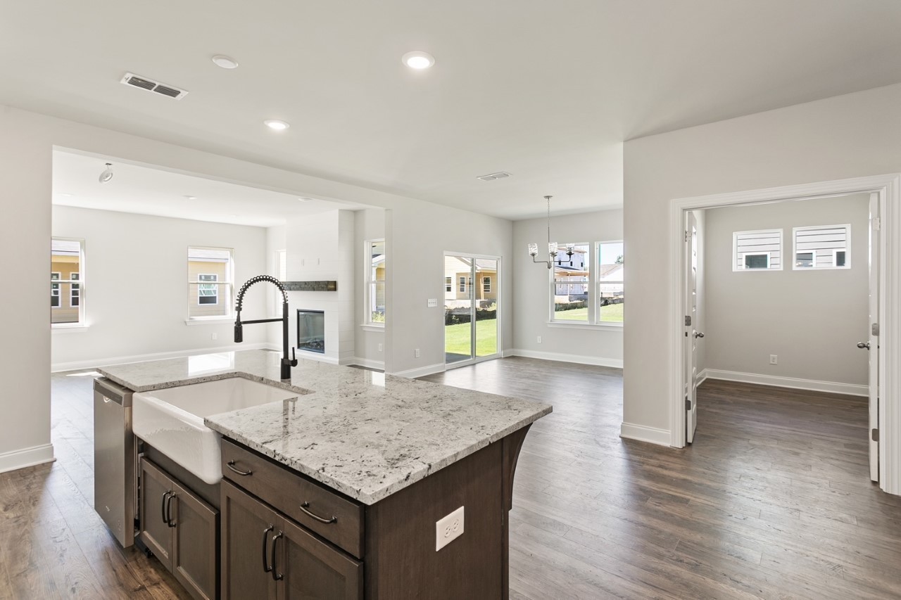 1108 Riverview Run Madison, TN 37115 - Photo 7 of 23 a kitchen with granite countertop kitchen island a sink appliances and wooden floor