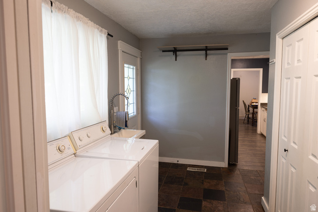827 South 600 East Logan, UT 84321 - Photo 9 of 30 Functional utility space featuring a window, tiled flooring, and a utility sink with a high-arc faucet