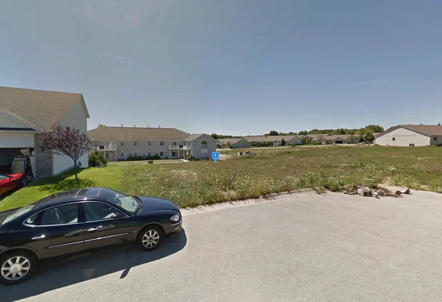 a view of a lake with a car parked in front of it