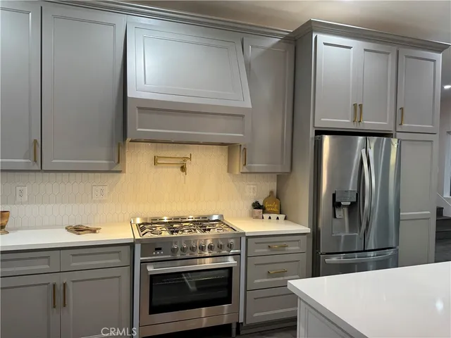 a kitchen with a stove oven and cabinets