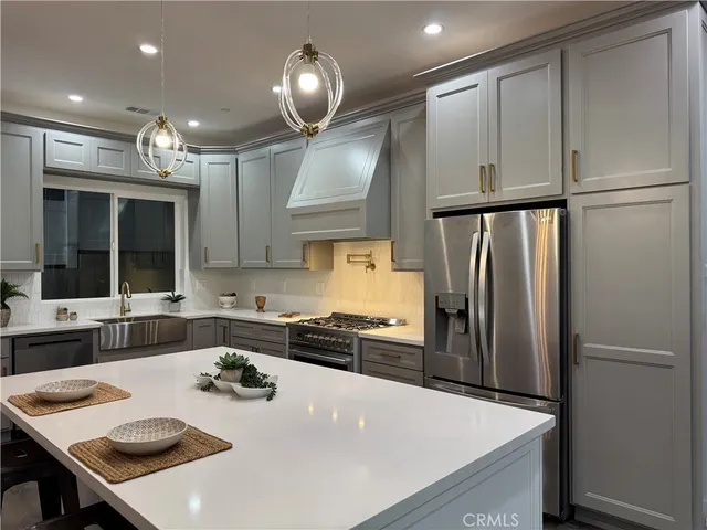 a kitchen with refrigerator and cabinets
