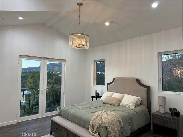 a bedroom with a large bed and a window