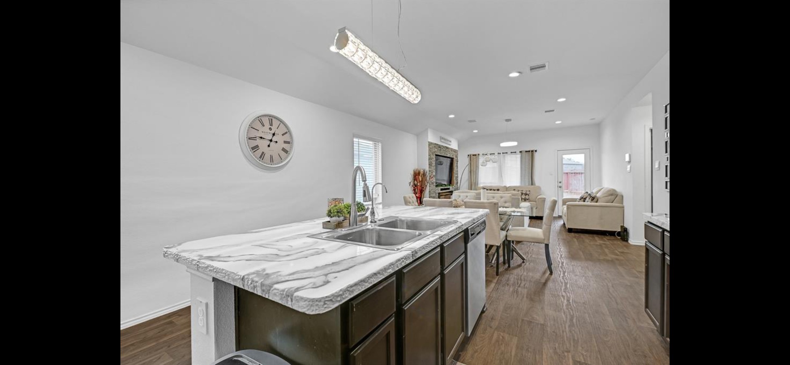22414 Goose Pasture Lane Spring, TX 77373 - Photo 2 of 11 At the heart of the home is an updated kitchen designed to impress—featuring striking marble-inspired countertops, rich cabinetry, abundant prep space, and an oversized island with seating that naturally becomes the gathering place for family and guests. The open-concept design flows effortlessly into the living and dining areas, making entertaining both functional and enjoyable.
At the heart of the home is an updated kitchen designed to impress featuring striking marble-inspired countertops,rich cabinet