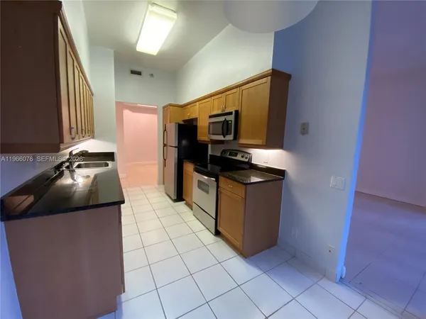 a kitchen with stainless steel appliances granite countertop a sink and a stove
