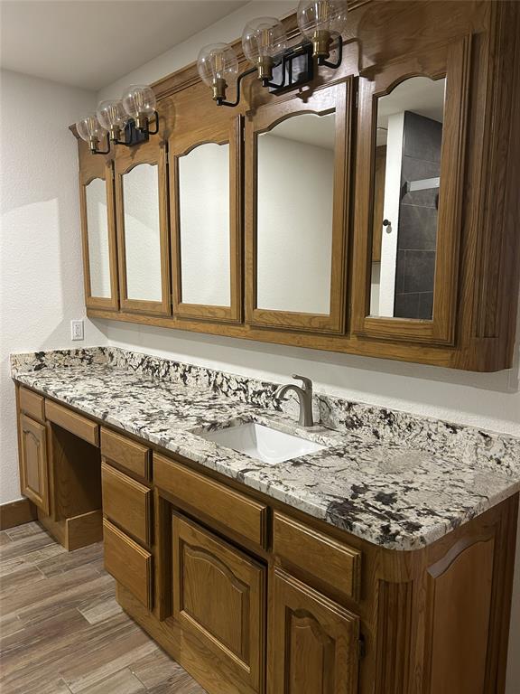 307 County Road 4790 Boyd, TX 76023 - Photo 11 of 25 a bathroom with a granite countertop sink and a mirror