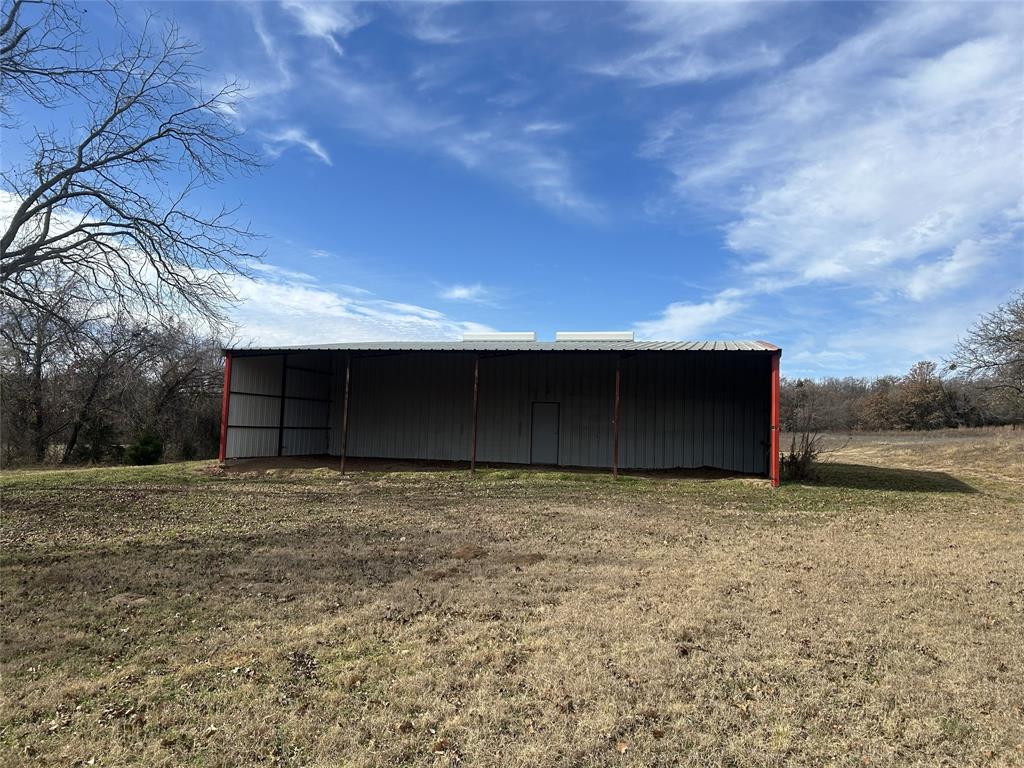 307 County Road 4790 Boyd, TX 76023 - Photo 21 of 25 a view of a fireplace with wooden fence