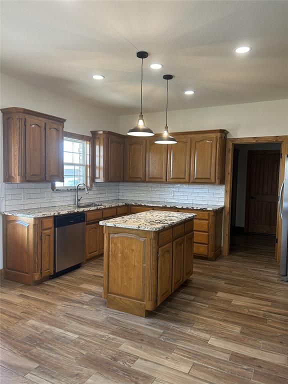307 County Road 4790 Boyd, TX 76023 - Photo 7 of 25 a large kitchen with a center island and wooden floor