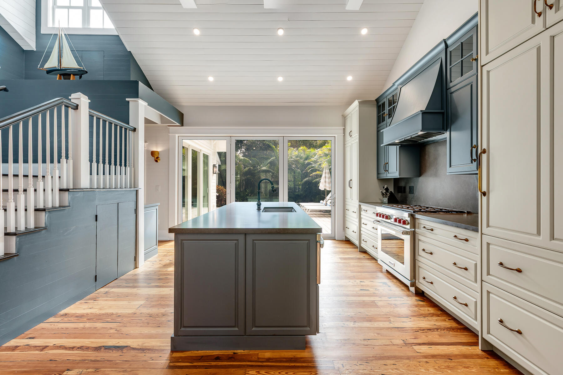 1230 South Street Key West, FL 33040 - Photo 22 of 60 a open kitchen with stainless steel appliances kitchen island granite countertop a refrigerator and wooden cabinets