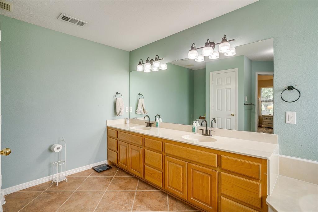 1050 Hampel Road Palmer, TX 75152 - Photo 22 of 35 a spacious bathroom with a double vanity sink and a mirror