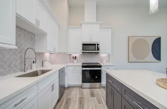 a kitchen with a sink stove top oven and microwave
