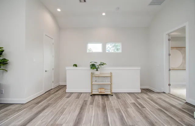 a view of a room with wooden floor and white doors