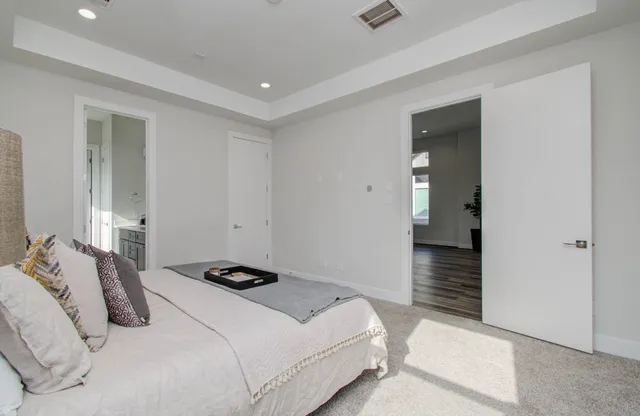 a bedroom with a bed and a large window