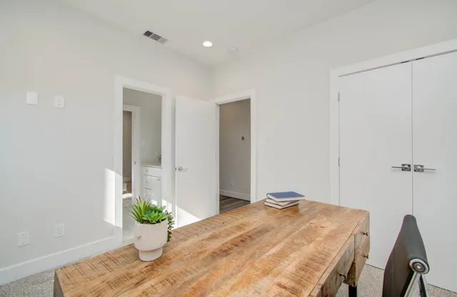 a bedroom with a bed and a potted plant