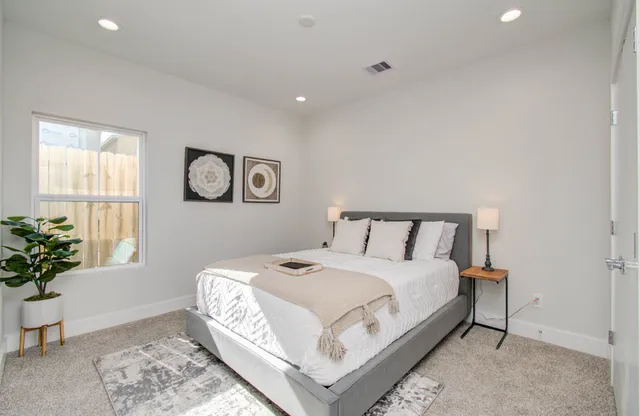 a large white bed in a white room