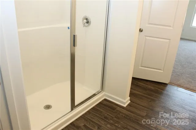 a bathroom with a glass shower door