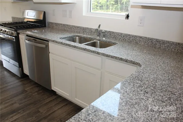 a kitchen with a sink stove and cabinets