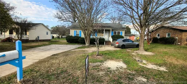 a view of a house with a yard covered in snow