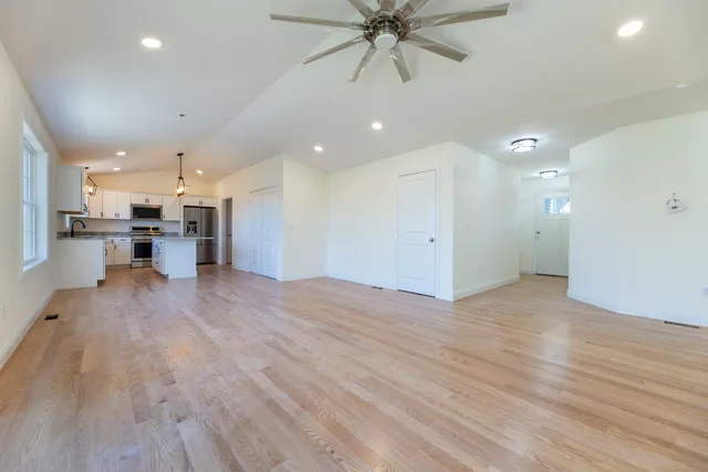 a view of a kitchen with a sink and a refrigerator