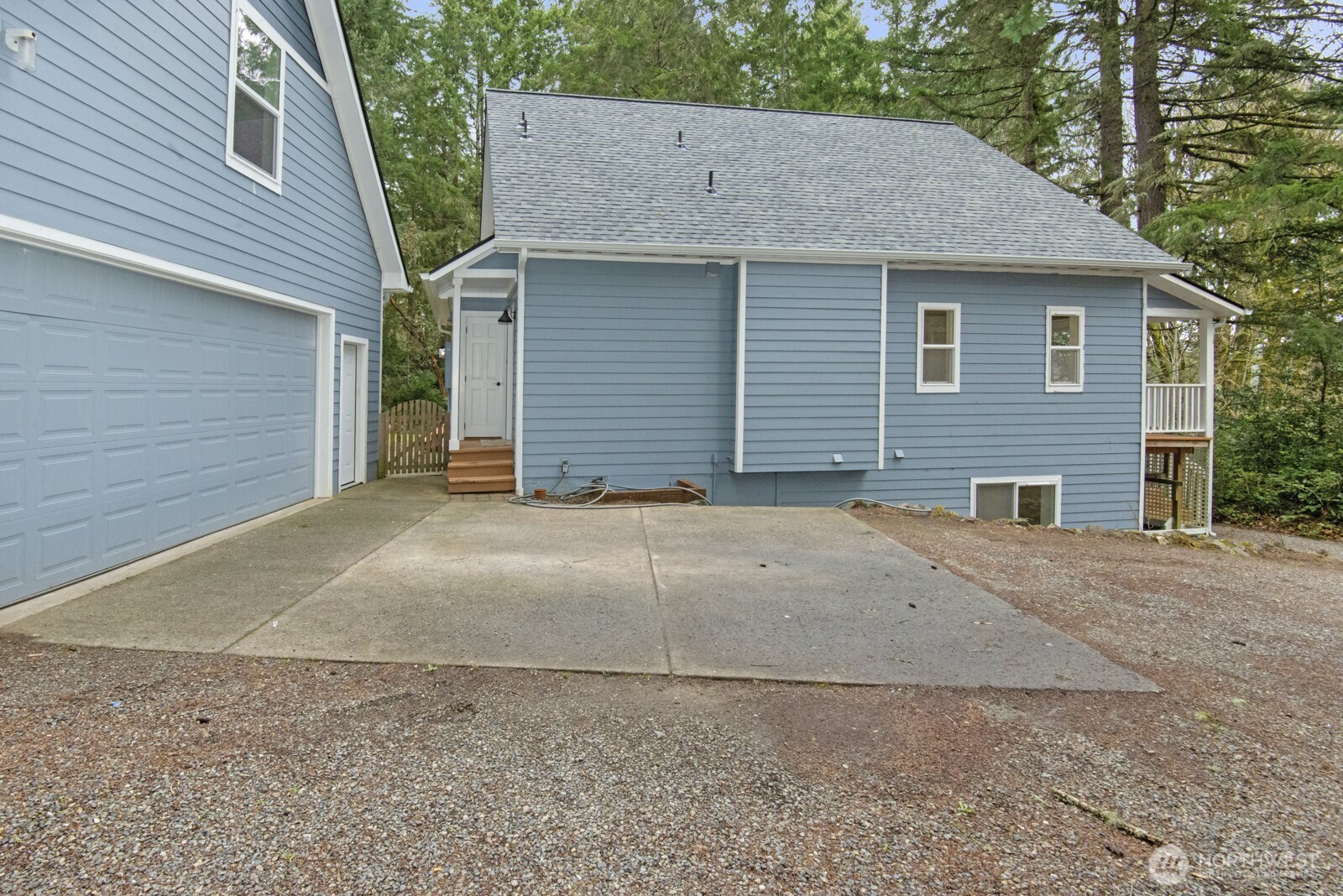 15002 Willow Road Southeast Port Orchard, WA 98367 - Photo 2 of 40 a view of a house with a yard and garage