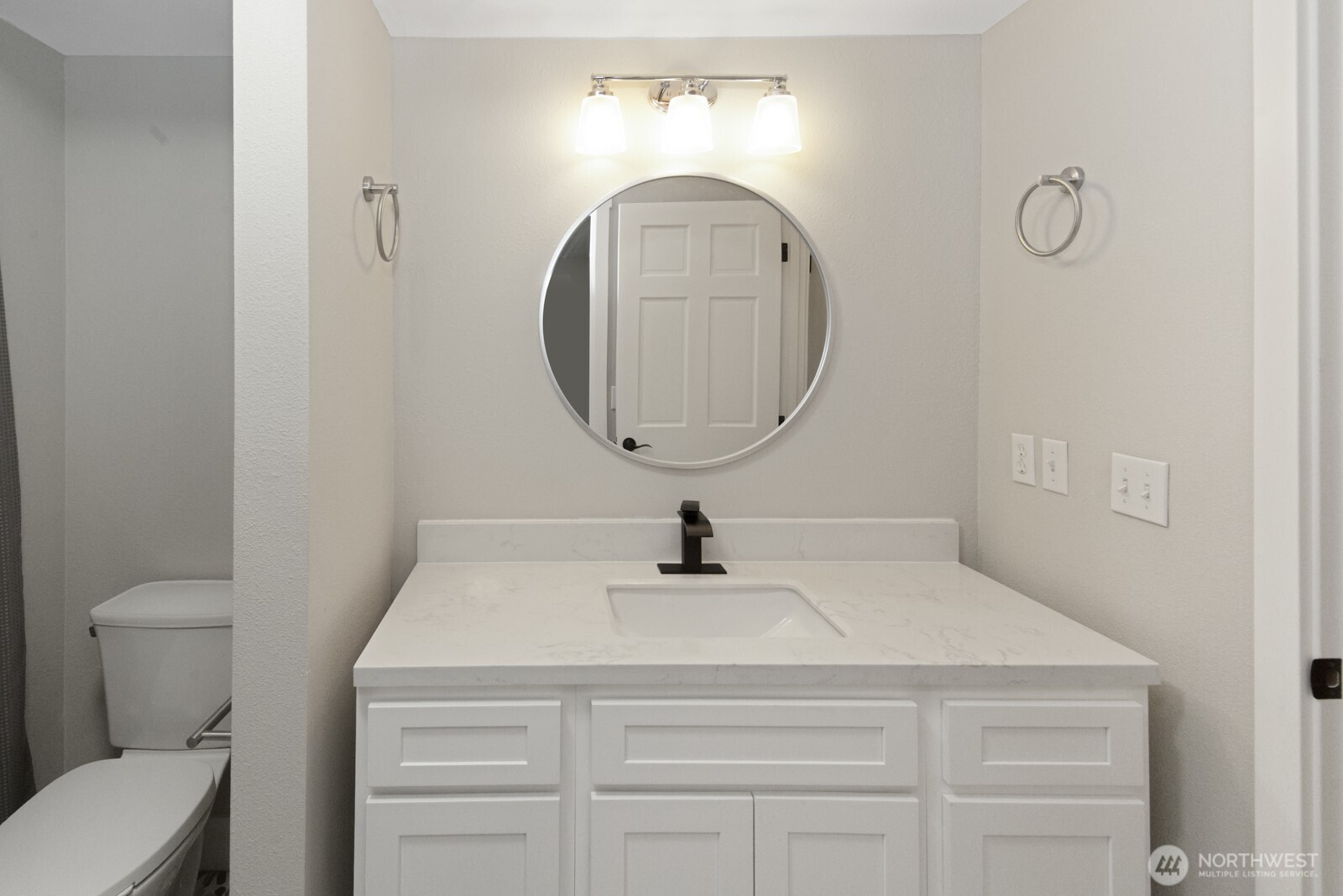 15002 Willow Road Southeast Port Orchard, WA 98367 - Photo 30 of 40 a bathroom with a sink a toilet and a mirror