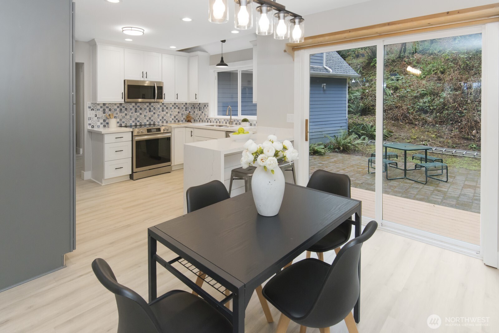 15002 Willow Road Southeast Port Orchard, WA 98367 - Photo 5 of 40 a view of a dining room with furniture and a floor to ceiling window