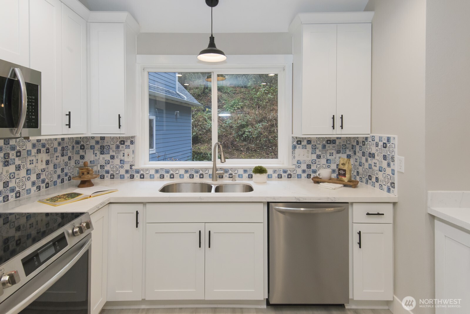 15002 Willow Road Southeast Port Orchard, WA 98367 - Photo 7 of 40 a kitchen with a sink stove and cabinets