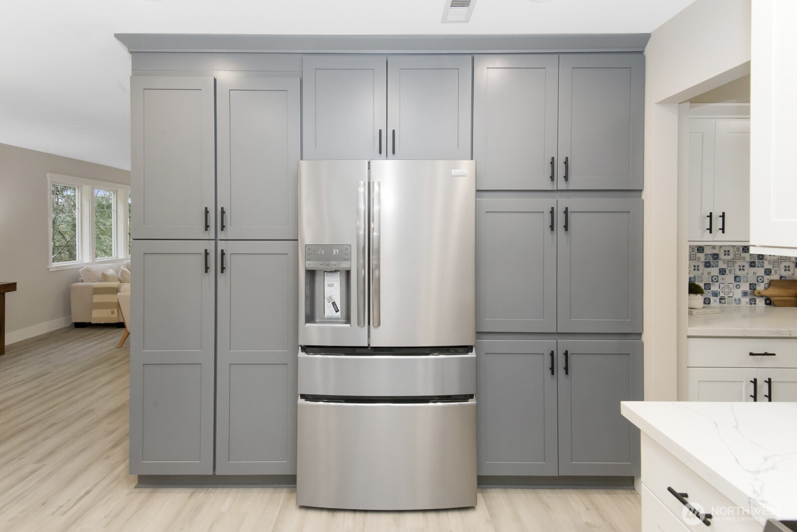 15002 Willow Road Southeast Port Orchard, WA 98367 - Photo 8 of 40 a white refrigerator freezer and a wooden floor in a kitchen