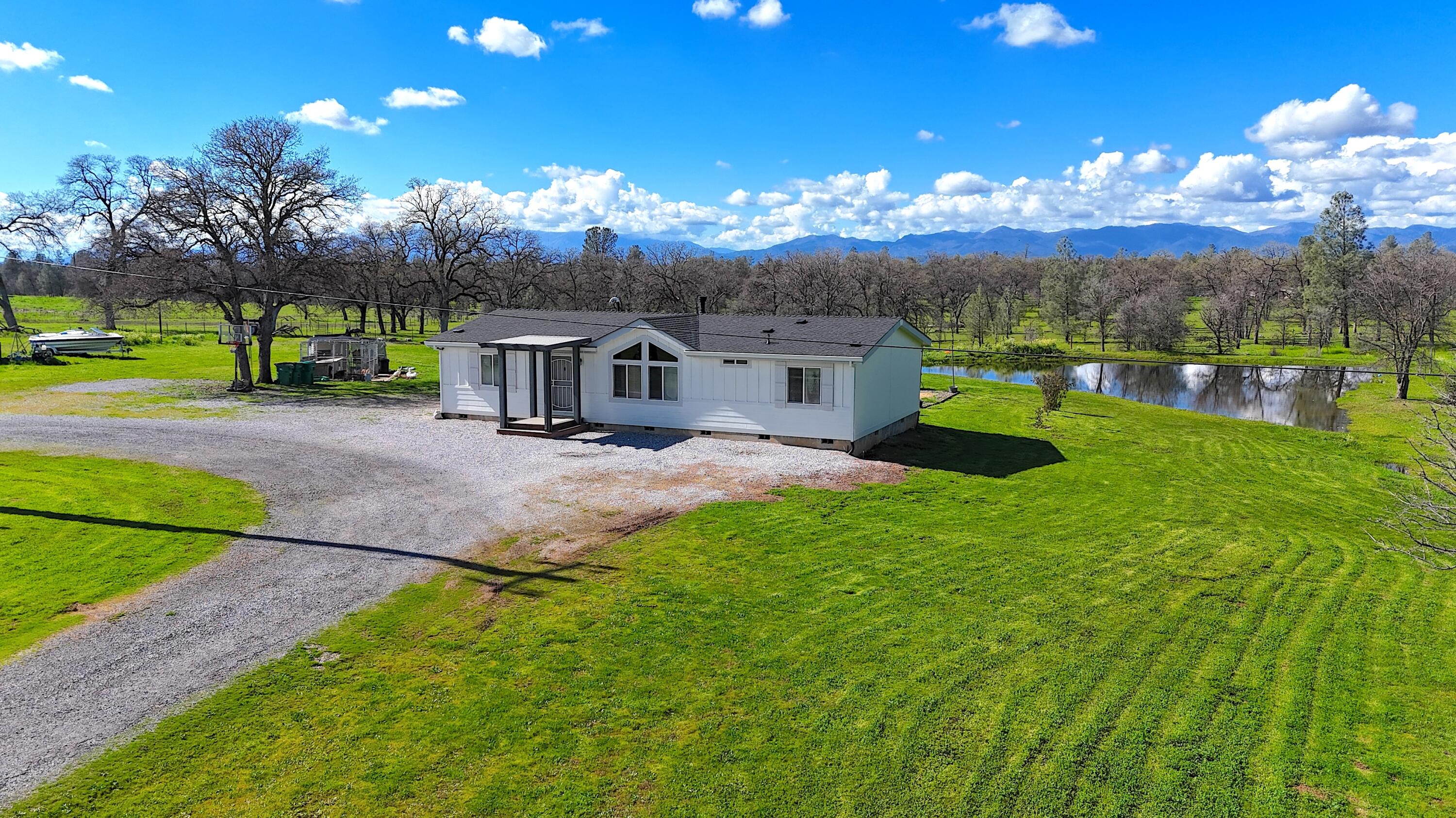 11636 Homestead Lane Redding, CA 96003 - Photo 1 of 37 a view of a house with a big yard