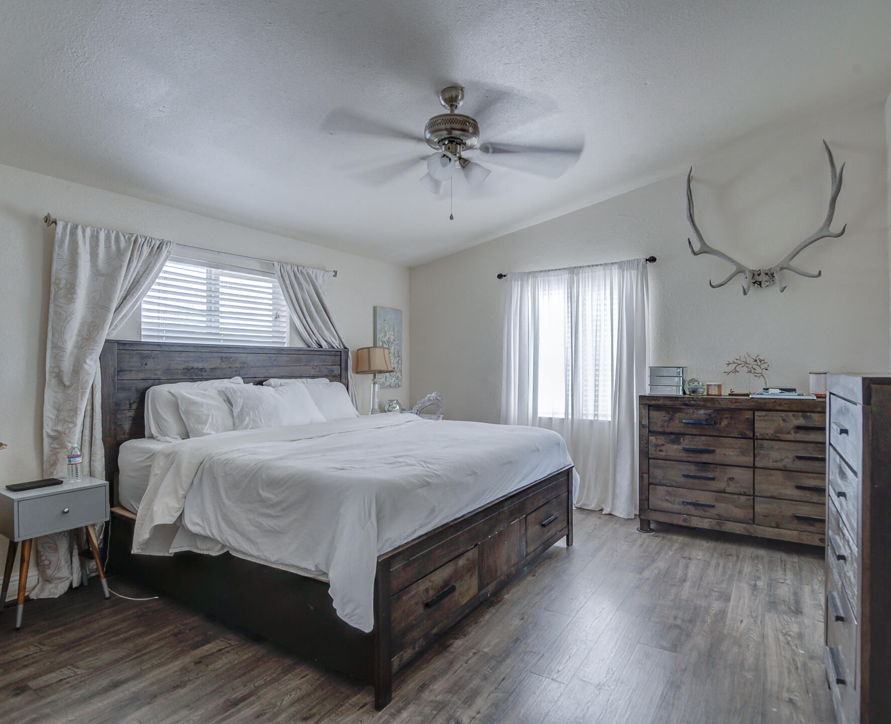11636 Homestead Lane Redding, CA 96003 - Photo 14 of 37 a bedroom with a bed and a chandelier