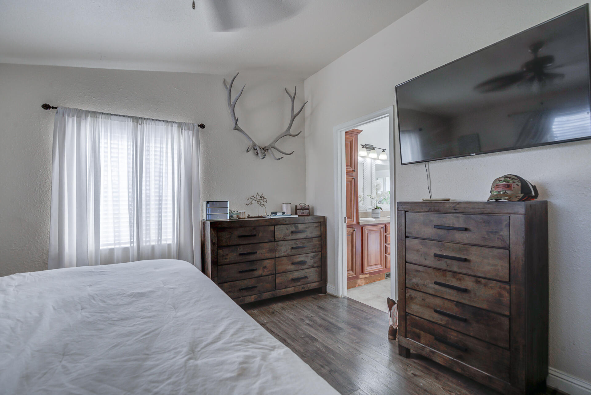 11636 Homestead Lane Redding, CA 96003 - Photo 15 of 37 a bedroom with a dresser and a flat screen tv