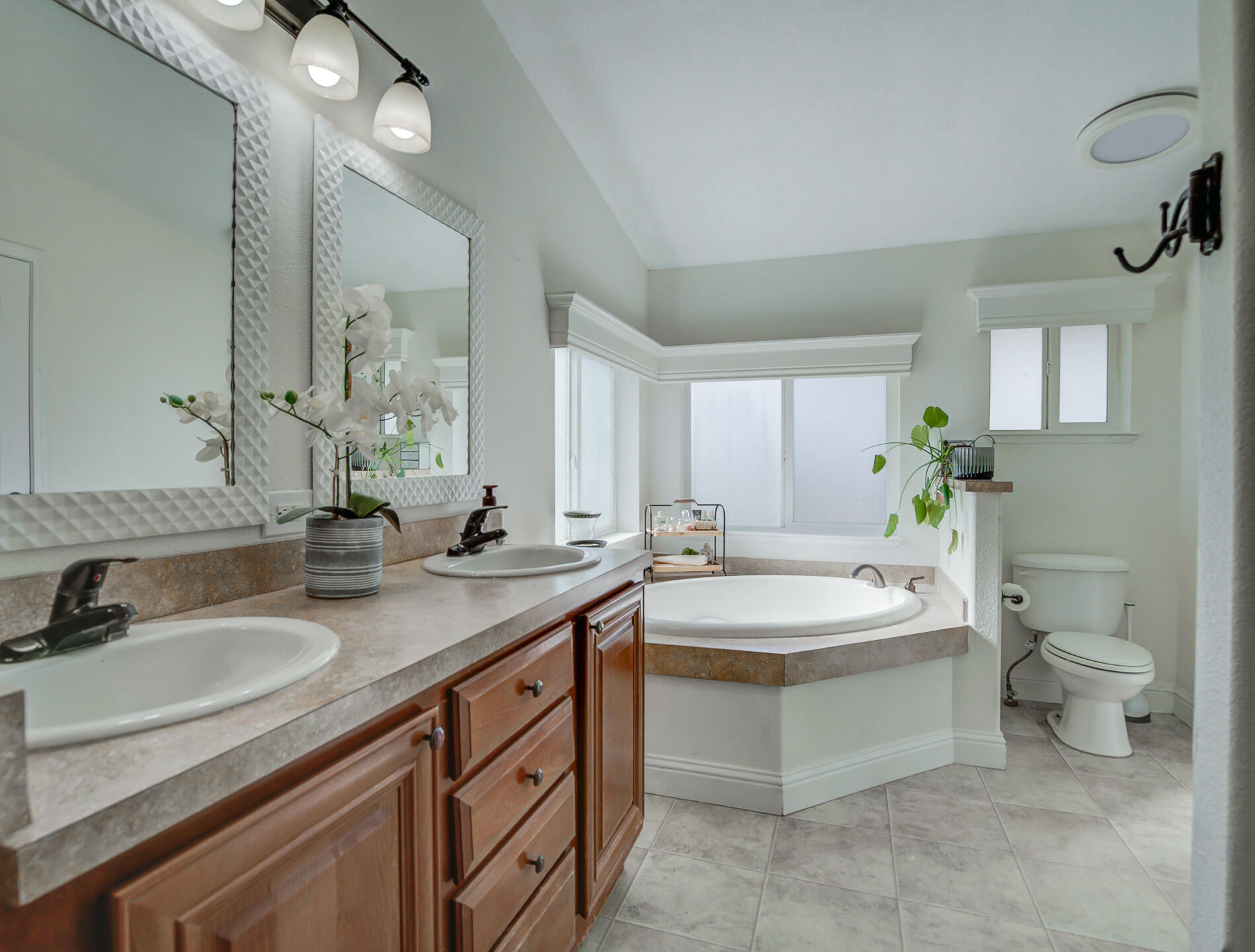 11636 Homestead Lane Redding, CA 96003 - Photo 16 of 37 a spacious bathroom with a double vanity sink toilet and a mirror