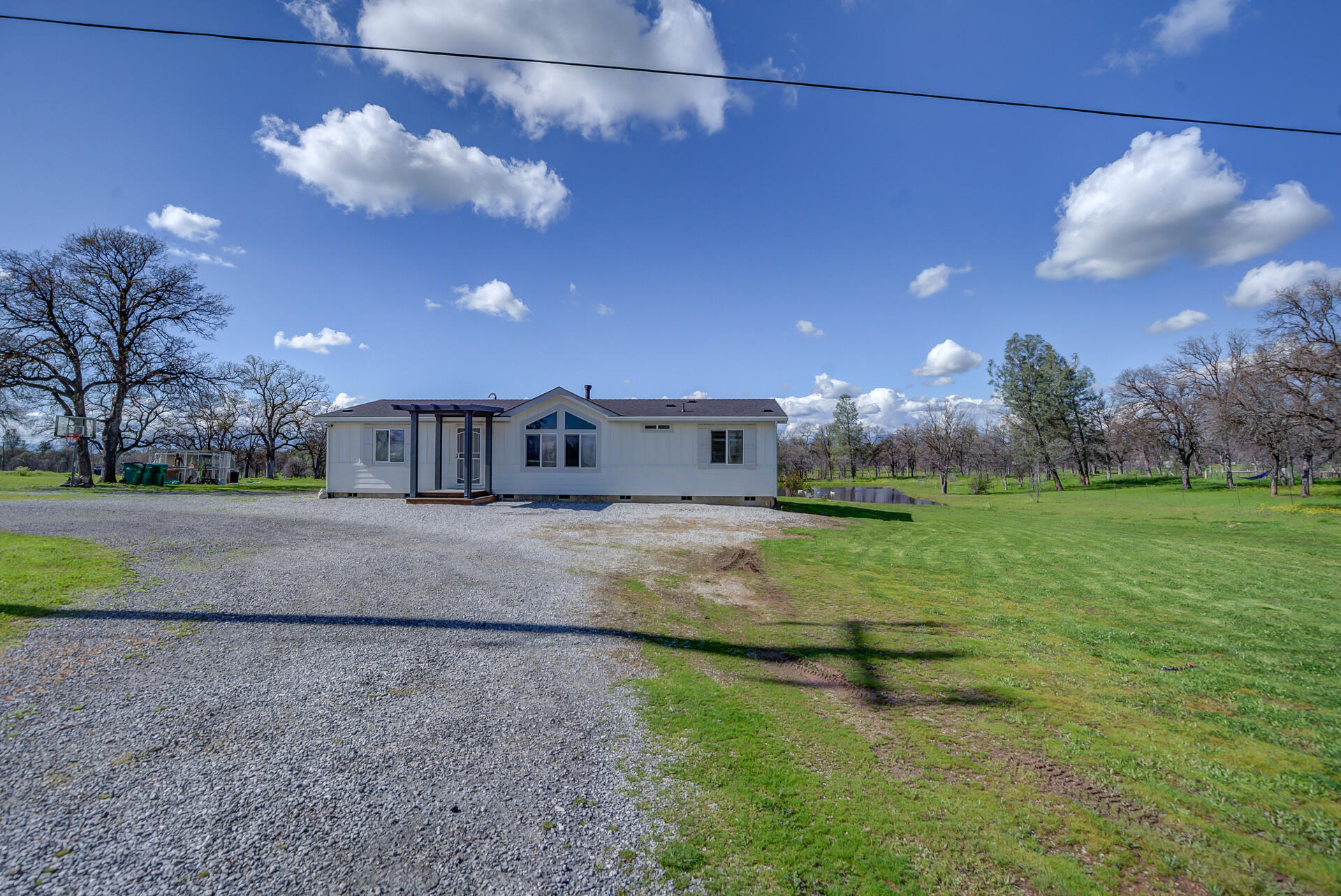 11636 Homestead Lane Redding, CA 96003 - Photo 2 of 37 a view of a big yard with a large tree