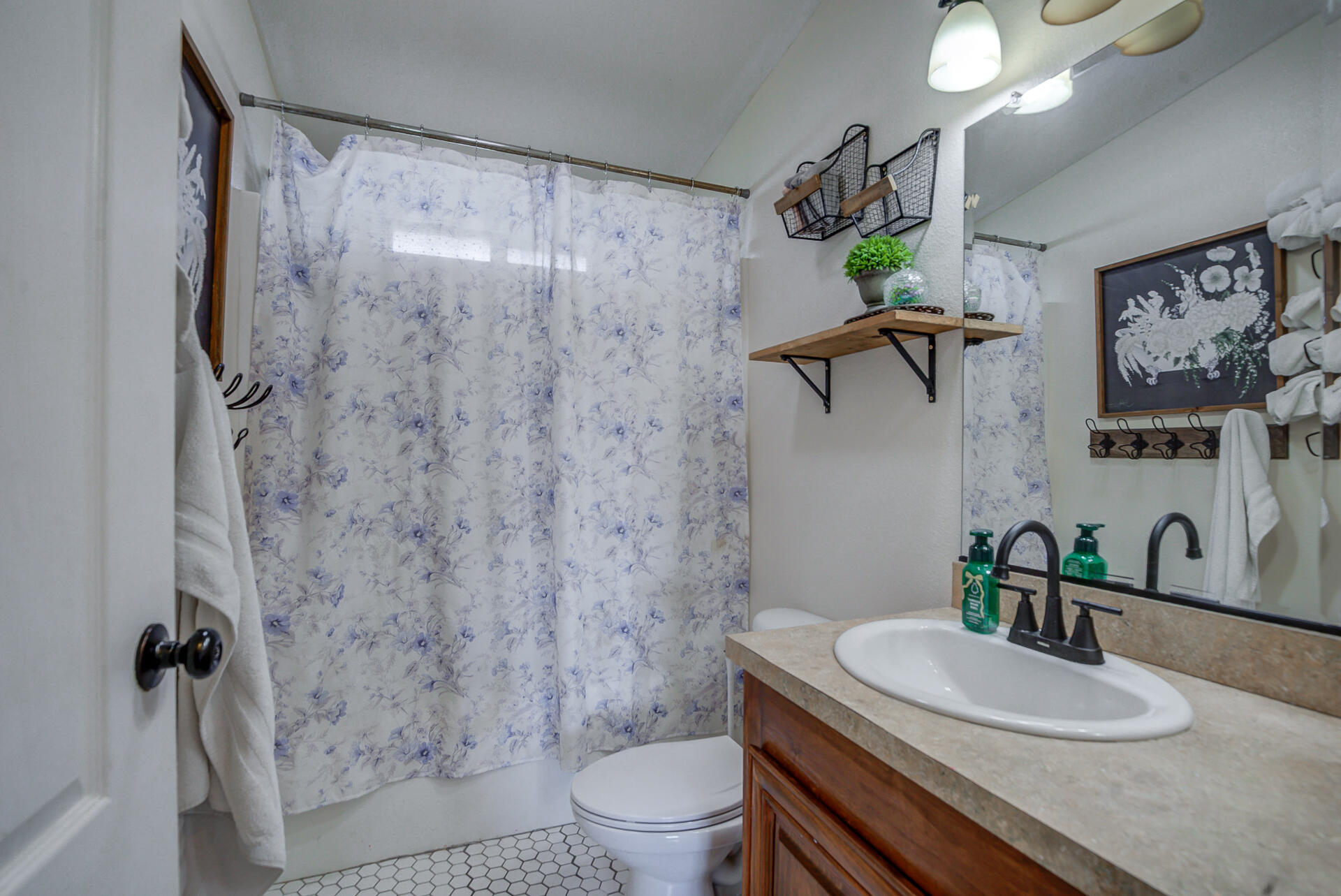 11636 Homestead Lane Redding, CA 96003 - Photo 21 of 37 a bathroom with a granite countertop sink a toilet and a mirror