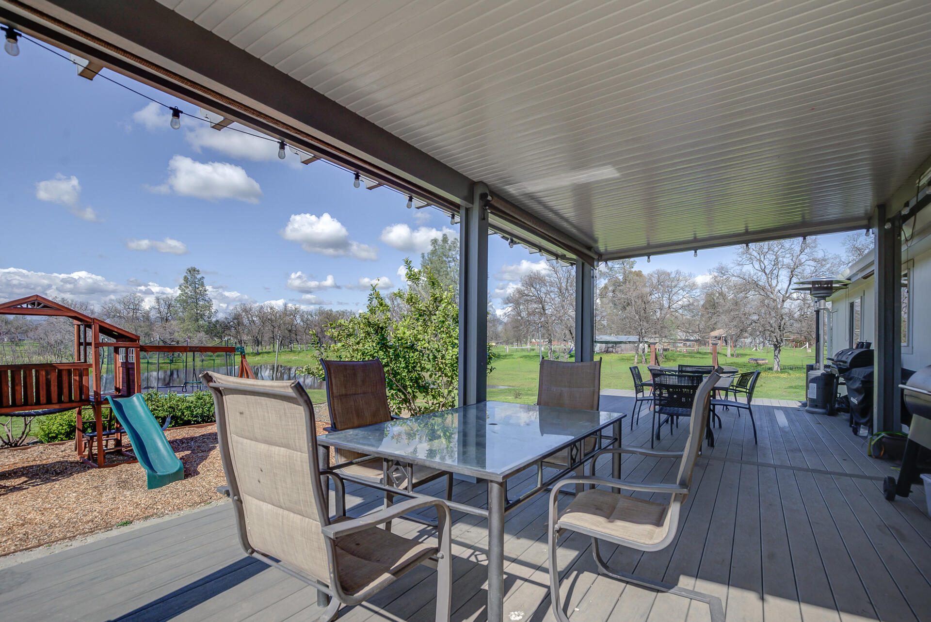 11636 Homestead Lane Redding, CA 96003 - Photo 23 of 37 a view of a patio with dining table and chairs