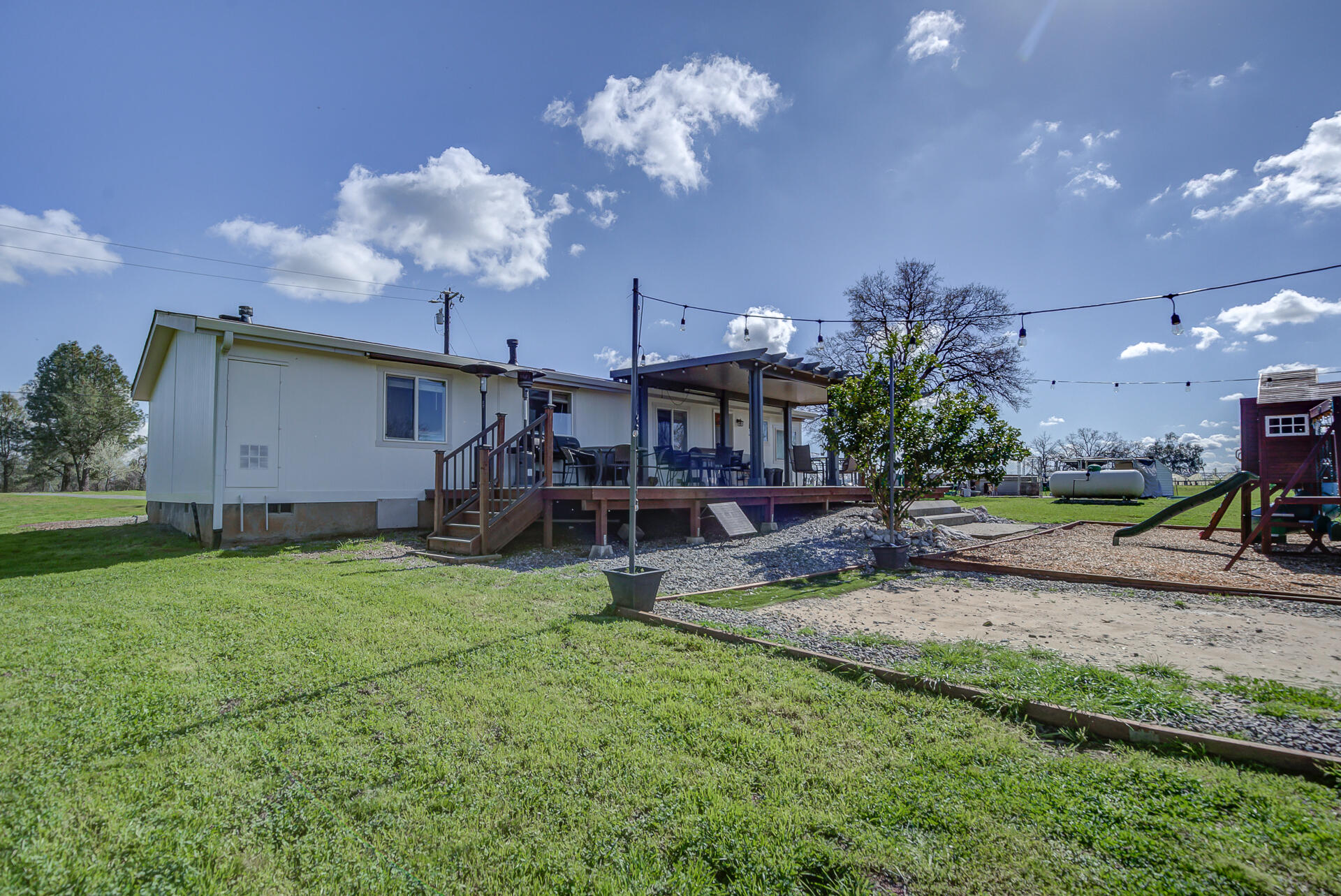 11636 Homestead Lane Redding, CA 96003 - Photo 25 of 37 a view of a house with backyard and a tree