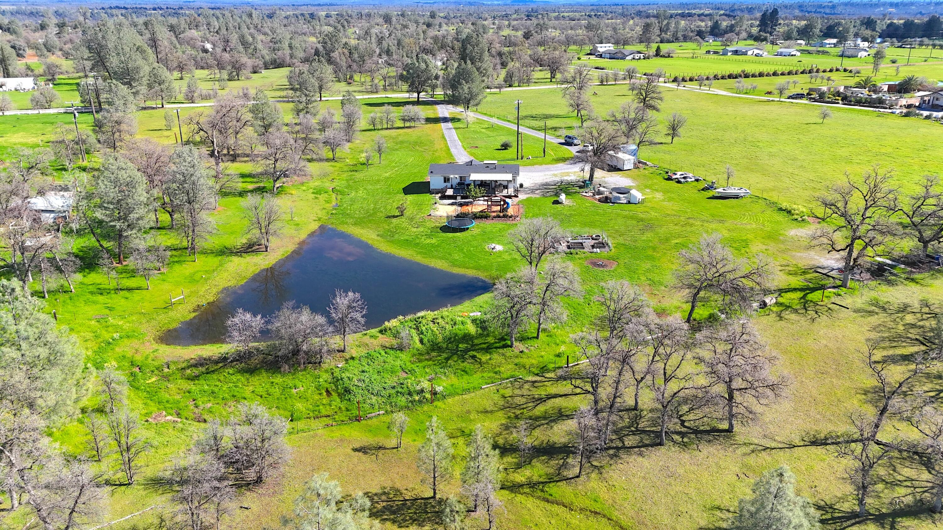 11636 Homestead Lane Redding, CA 96003 - Photo 28 of 37 a view of a lake with a building in the background