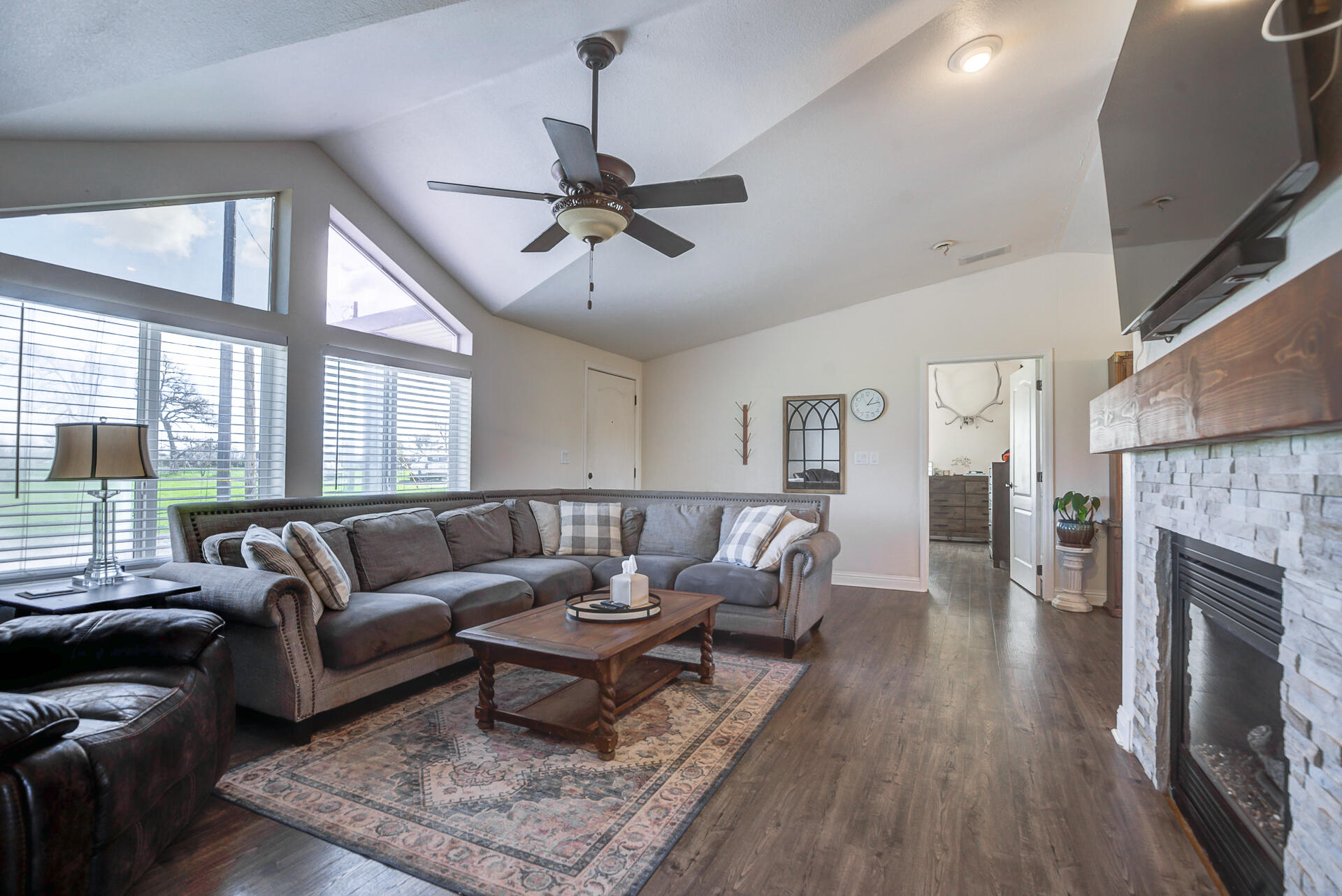 11636 Homestead Lane Redding, CA 96003 - Photo 6 of 37 a living room with furniture a fireplace and a floor to ceiling window