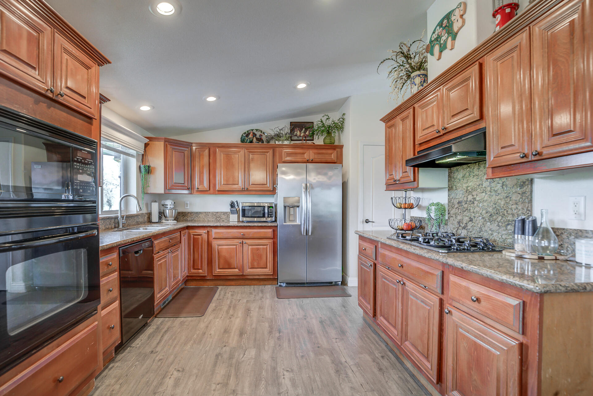 11636 Homestead Lane Redding, CA 96003 - Photo 9 of 37 a kitchen with stainless steel appliances granite countertop a refrigerator a stove top oven a sink and dishwasher