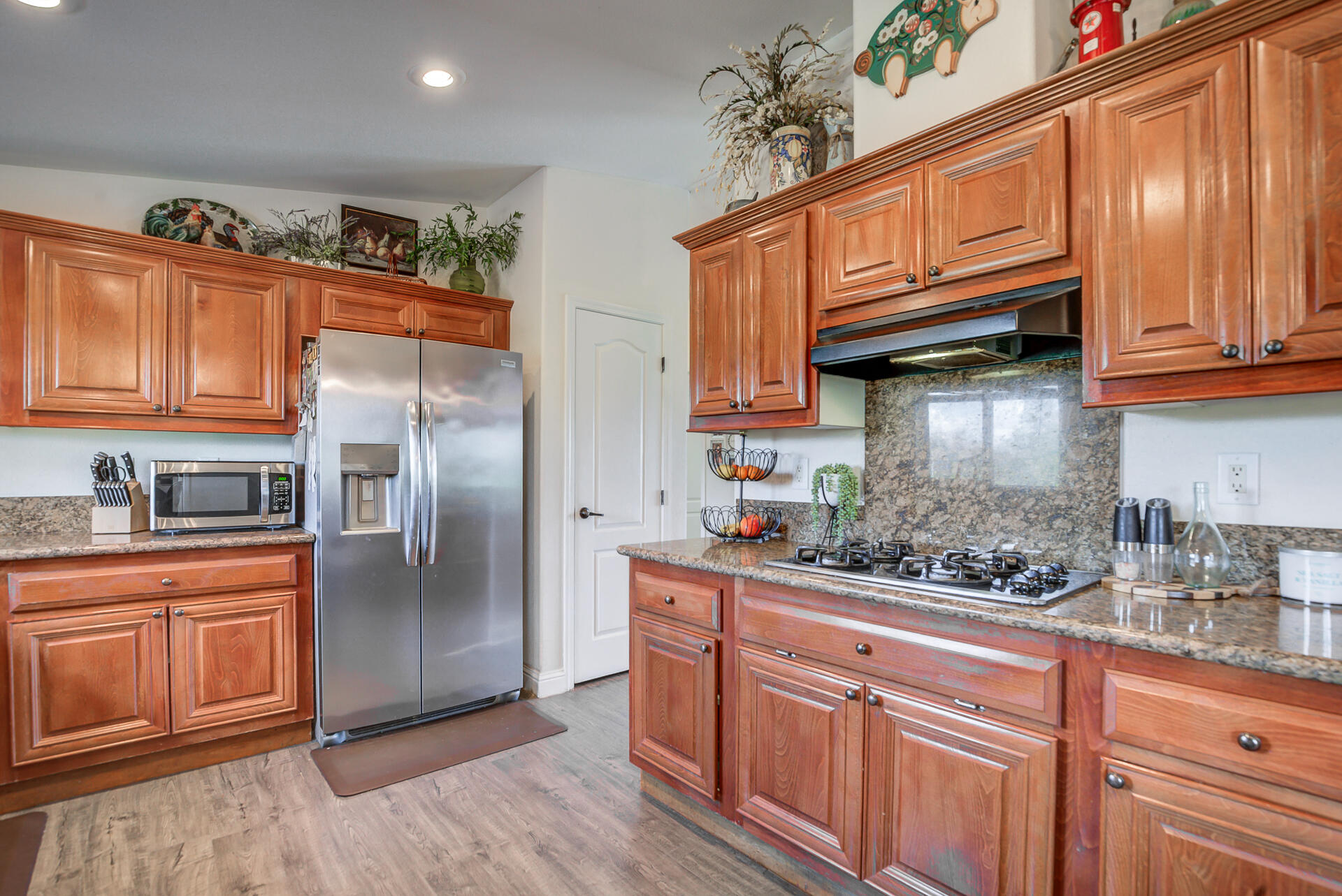 11636 Homestead Lane Redding, CA 96003 - Photo 10 of 37 a kitchen with stainless steel appliances granite countertop a refrigerator and wooden cabinets