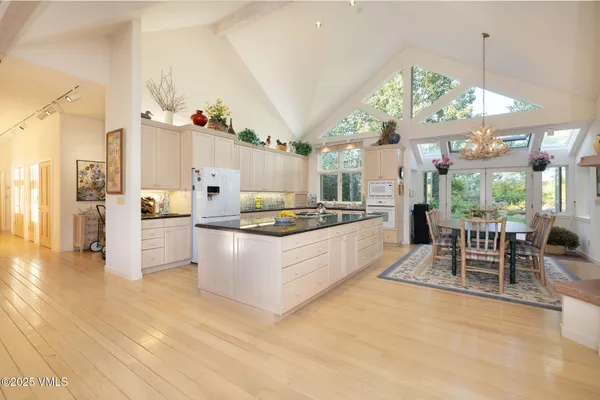 a kitchen with stainless steel appliances granite countertop a stove and a large countertops with cabinets