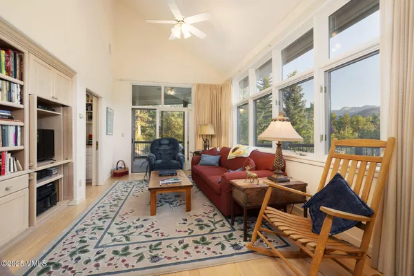 a view of a balcony with wooden floor and outdoor seating