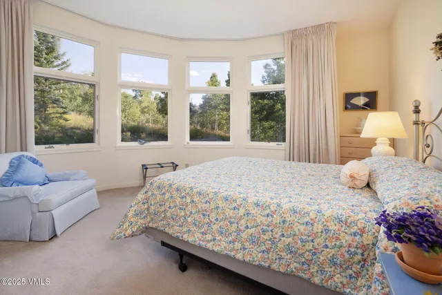 a bedroom with a bed and dresser with mirror